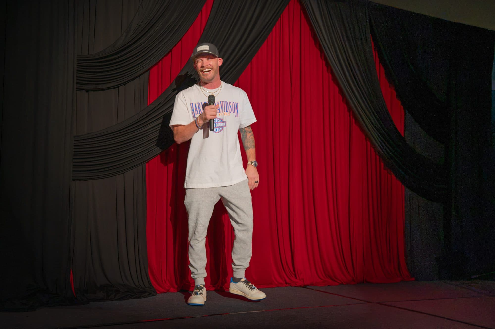 Comedian performing a stand-up set on stage at Mic Drop Masters 2026.