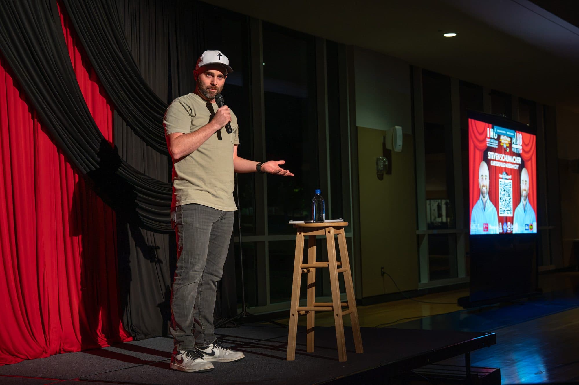 Comedian performing a stand-up set on stage at Mic Drop Masters 2026.