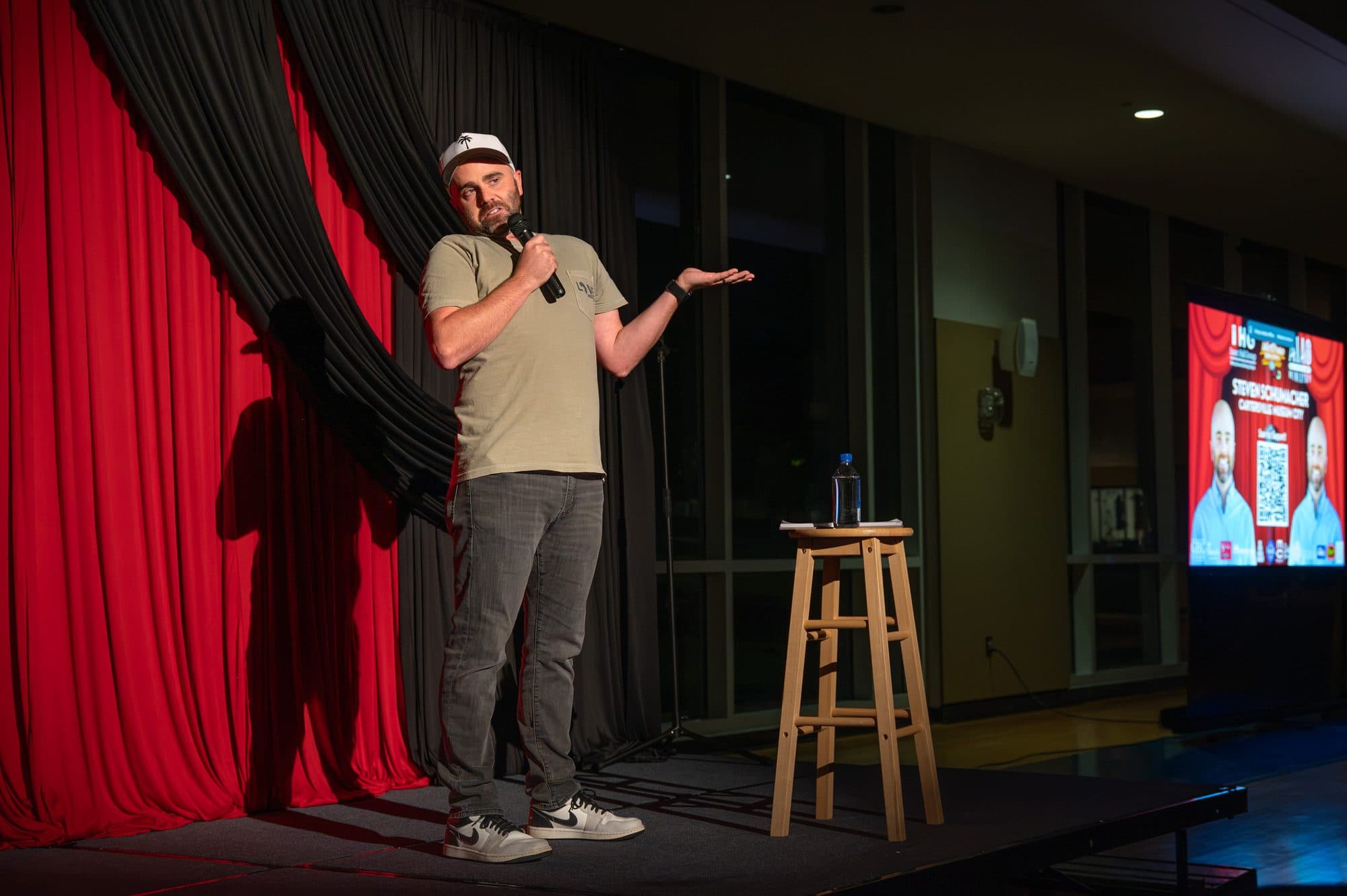 Comedian performing a stand-up set on stage at Mic Drop Masters 2026.