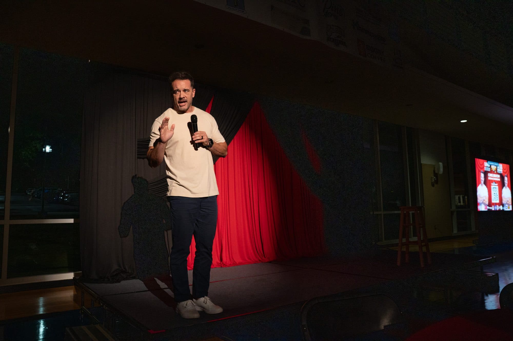 Comedian performing a stand-up set on stage at Mic Drop Masters 2026.