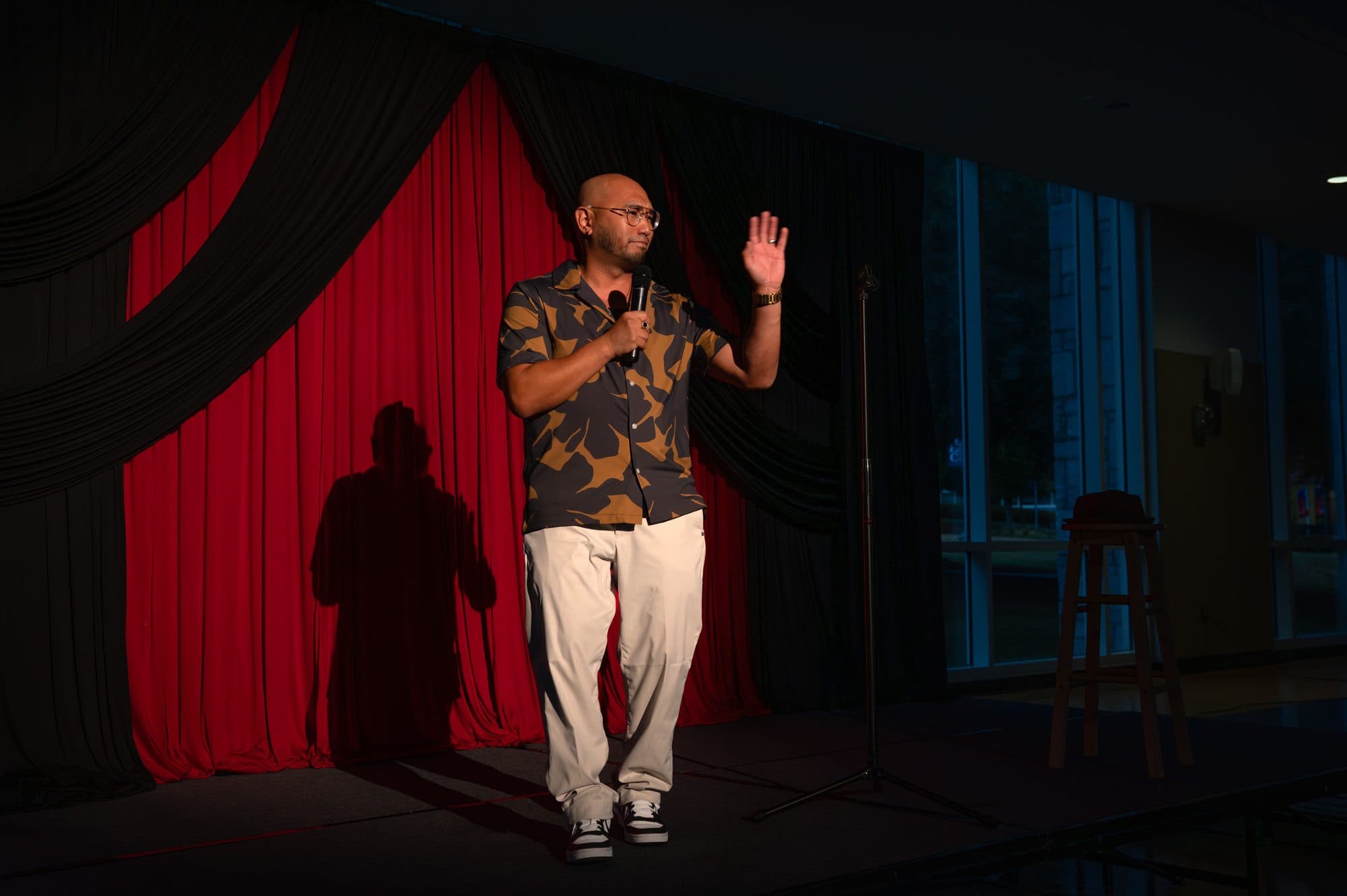 Comedian performing a stand-up set on stage at Mic Drop Masters 2026.