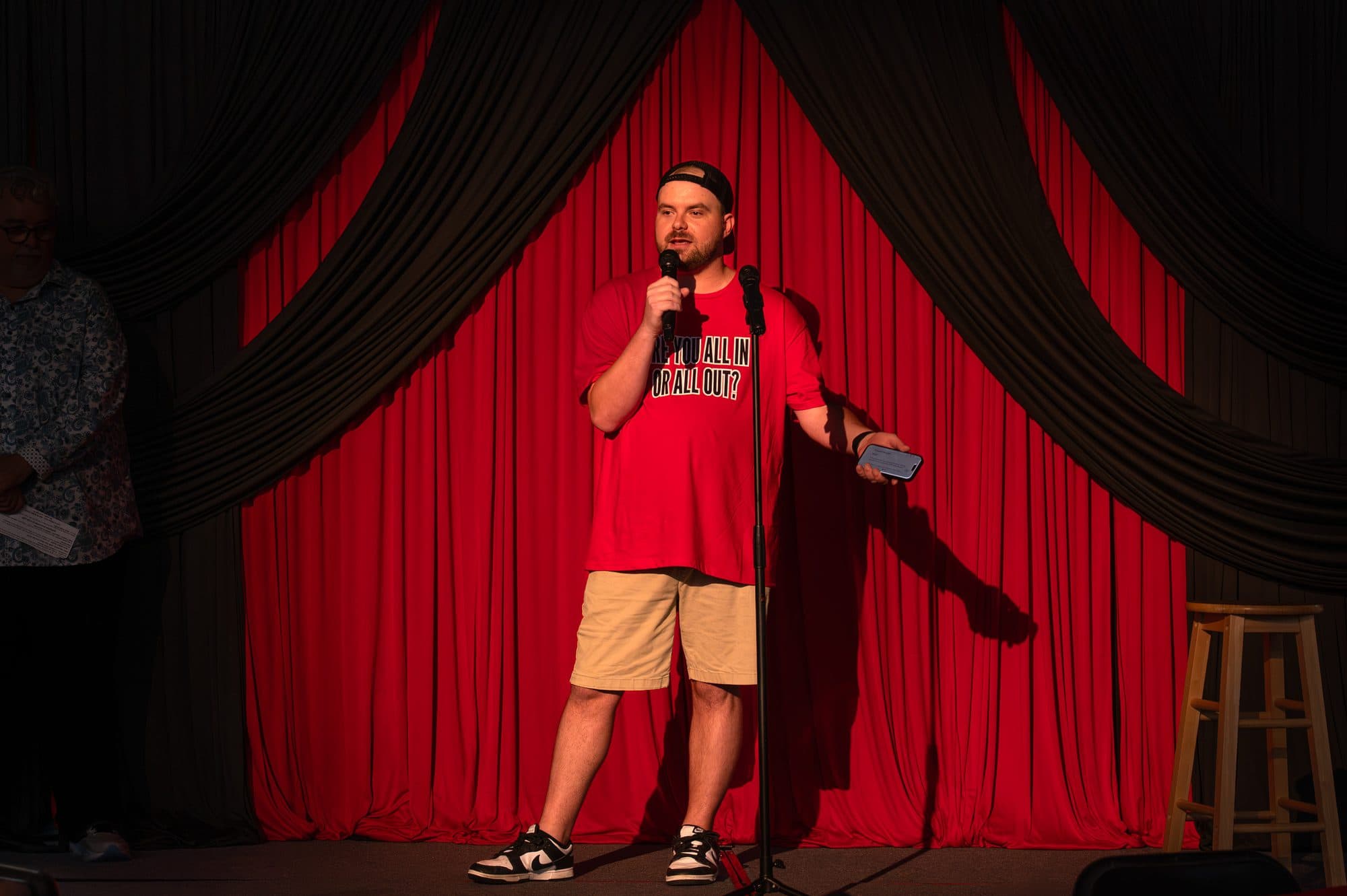 Speaker addressing the crowd at the Mic Drop Masters 2026 fundraiser.