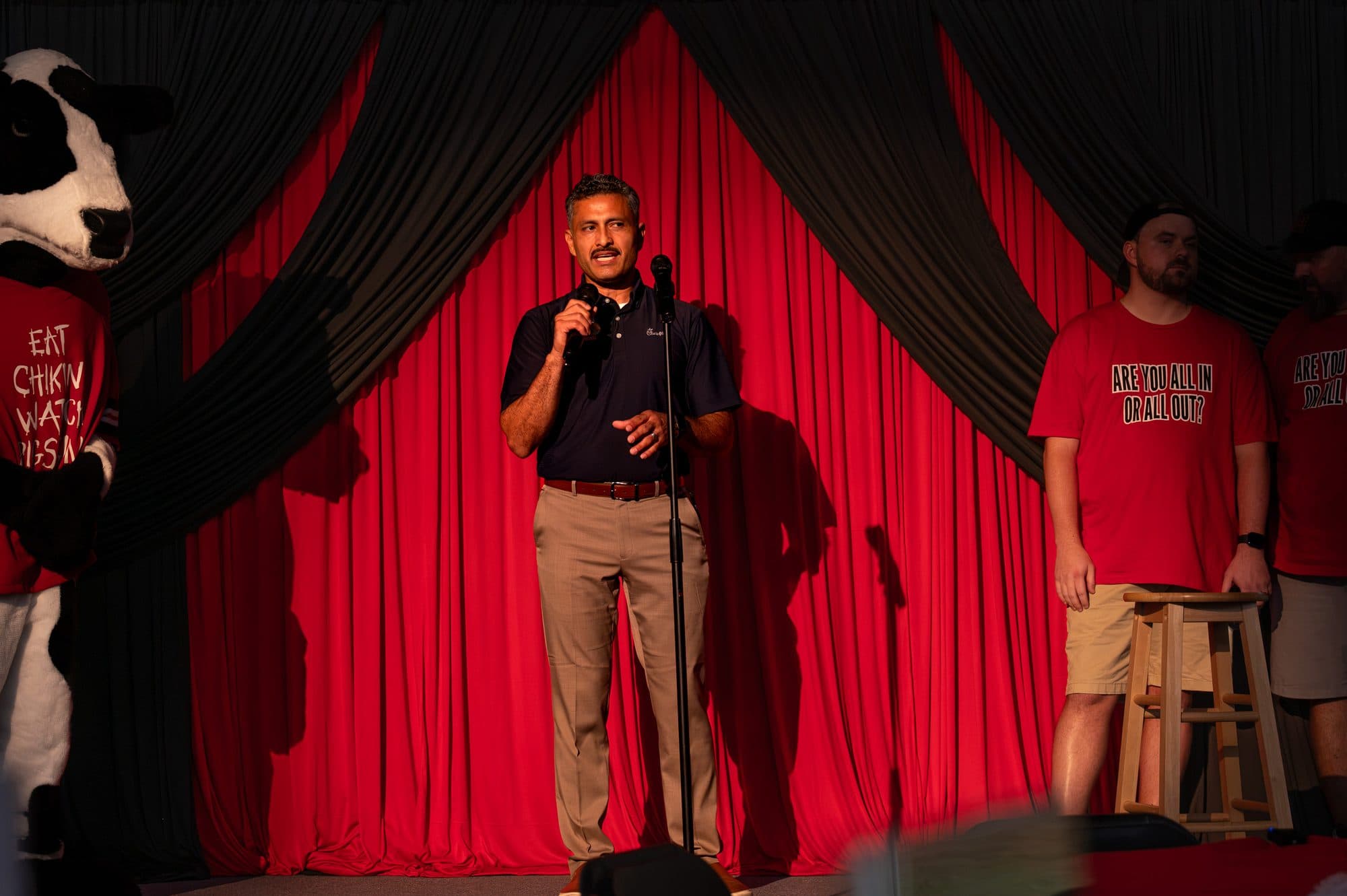 Speaker addressing the crowd at the Mic Drop Masters 2026 fundraiser.